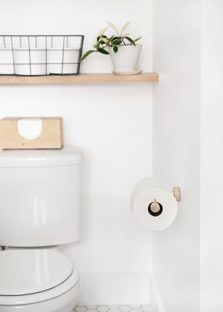 A wooden toilet roll holder
