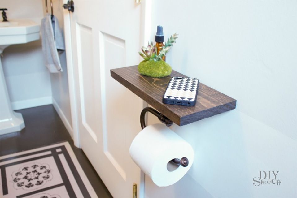 A wooden toilet paper holder in a bathroom